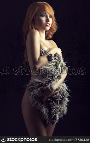 Beautiful, gorgeous, ginger girl cover her nude body with fluffy fur. She has got amazing bracelet and earrings.