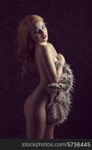 Beautiful, gorgeous, ginger girl cover her nude body with fluffy fur. she is sexy and looking in camera&#xA;