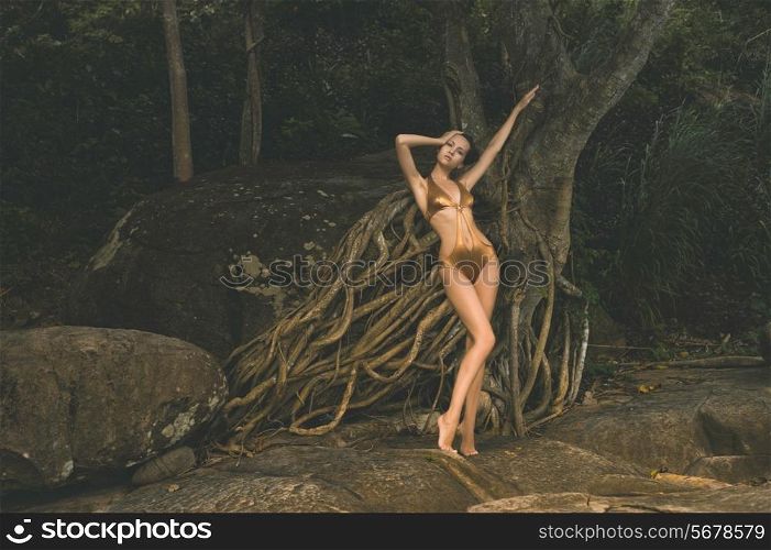 Beautiful graceful lady with an old mighty tree