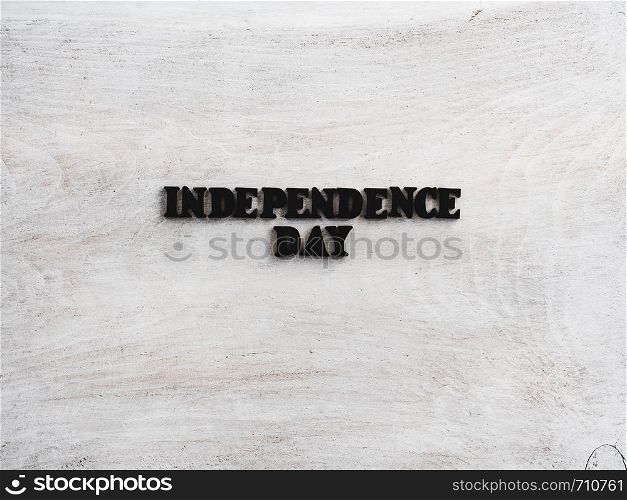 Beautiful greeting card for Independence Day. Wooden letters with a congratulatory inscription on a white background. Close-up, top view. Congratulations for loved ones, relatives, friends, colleagues. Beautiful, bright greeting card with a holiday