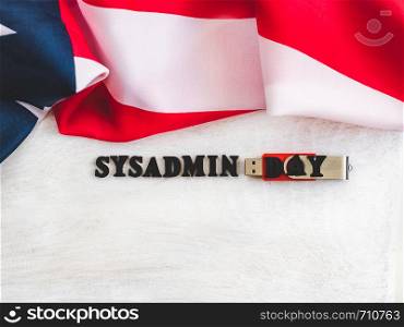 Beautiful greeting card for Sysadmin Day. Wooden letters with a congratulatory inscription on a white background. Close-up, top view. Congratulations for loved ones, friends and colleagues. Beautiful, bright greeting card with a holiday