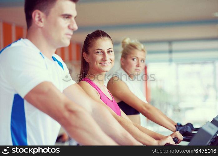 Beautiful group of young women friends exercising on a treadmill at the bright modern gym. friends exercising on a treadmill at the bright modern gym