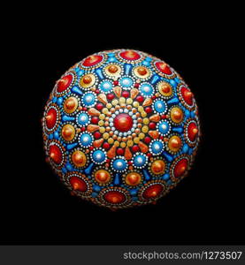 Beautiful hand painted mandala rock on black background