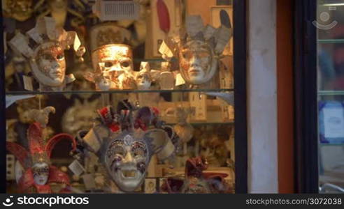 Beautiful handmade masks exhibited in show-window of the shop in the street. Traditional Venetian carnival