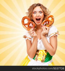 Beautiful happily excited sexy Oktoberfest woman wearing a traditional Bavarian dress dirndl holding two pretzels on colorful abstract cartoon style background.