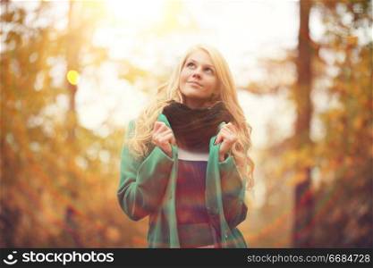 beautiful happy blond woman in autumn park