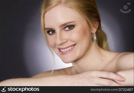 Beautiful Happy Blond Woman Smiling Big in Head and Shoulders Beauty Pose