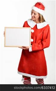 Beautiful happy blonde woman in Santa Claus clothes smiling with white board in her hands. Young female with blue eyes, isolated on white