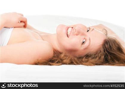 beautiful happy caucasian woman is lying in bed at morning