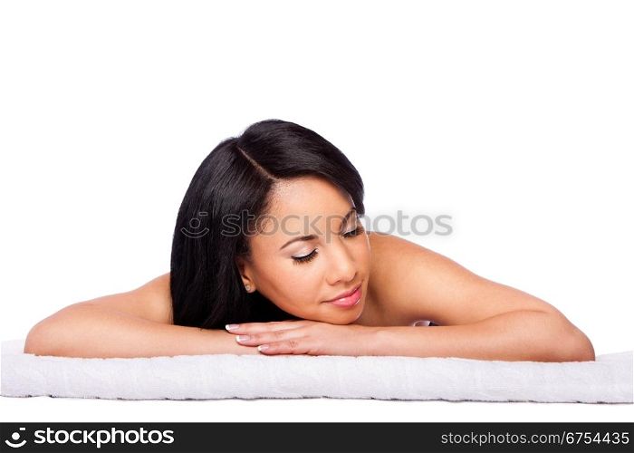 Beautiful happy female face, woman laying relaxing on white towel at spa massage beauty treatment parlor. Healthy Skincare concept, isolated.