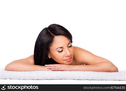 Beautiful happy female face, woman laying relaxing on white towel at spa massage beauty treatment parlor. Healthy Skincare concept, isolated.