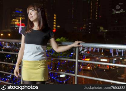 Beautiful happy Japanese female with colorful lights in background