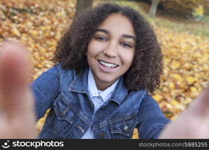 Beautiful happy mixed race African American girl teenager female child smiling with perfect teeth taking selfie photograph