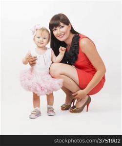 Beautiful happy mother with baby daughter on white background