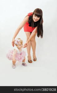 Beautiful happy mother with baby daughter on white background