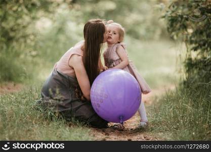 Beautiful happy mother with daughter having fun in green field holding balloons. mother and daughter with balloons. Mom, kid, mother.. mother and daughter with balloons. Beautiful happy mother with daughter having fun in green field holding balloons.mother and daughter with balloons. Beautiful happy mother with daughter having fun in green field holding balloons. Mom, kid, mother.
