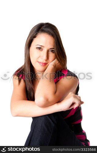 Beautiful happy relaxed young woman sitting leaning arms on knee, isolated.