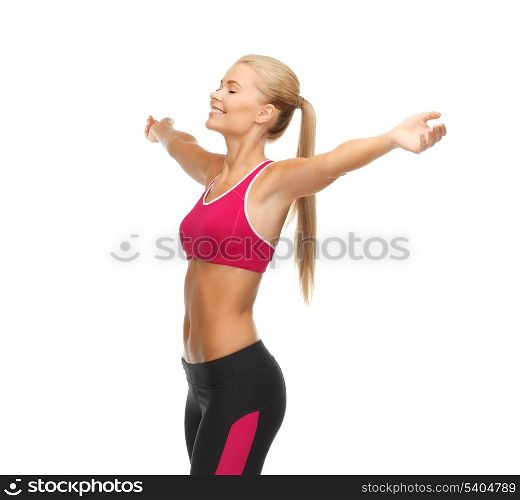 beautiful happy sportswoman with raised up hands