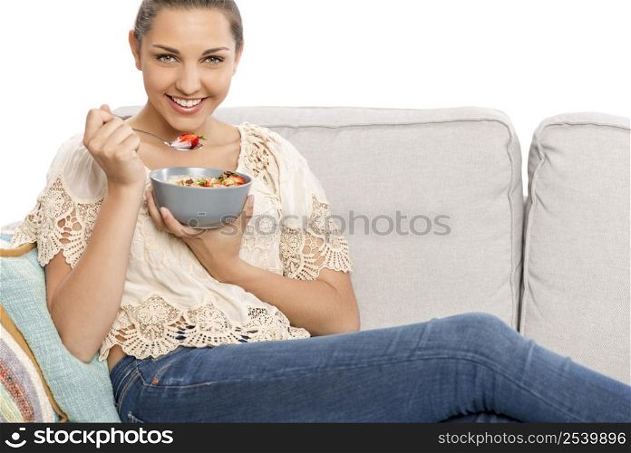 Beautiful happy woman at home eating a healthy bowl