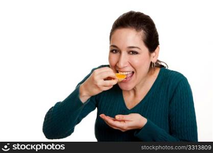 Beautiful happy woman eating a slice of juicy mandarin orange fruit full of vitamin C for a healthy diet, isolated.