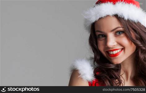 Beautiful happy woman in Santa Claus clothes. Woman in Santa Claus clothes