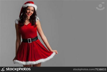 Beautiful happy woman in Santa Claus clothes. Woman in Santa Claus clothes