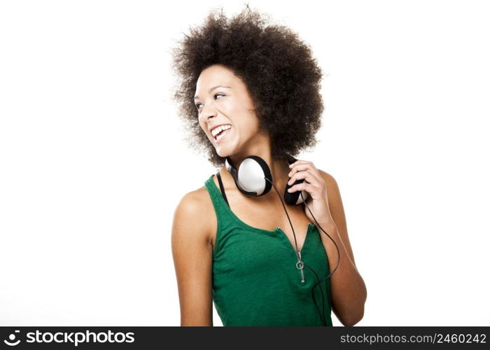 Beautiful happy woman laughing with headphones on the neck, isolated on white background