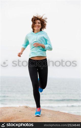Beautiful happy woman running on the beach