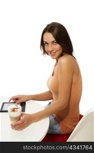 beautiful happy woman sitting at a table with latte macchiato and a ebook reader. beautiful happy woman sitting at a table with latte macchiato and a ebook reader on white background