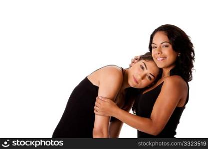 Beautiful happy youg woman couple together with face resting on chest of other calming her, both dressed in black, isolated.
