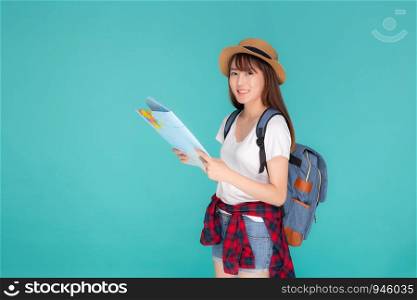 Beautiful happy young asian woman travel holding and looking a paper map isolated on blue background, asia girl search journey with direction in vacation trip with cheerful for leisure.