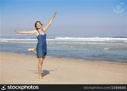 Beautiful happy young woman enjoying the beach