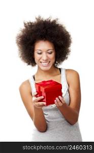 Beautiful happy young woman holding a red christmas gift, isolated on white