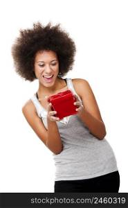Beautiful happy young woman holding a red christmas gift, isolated on white