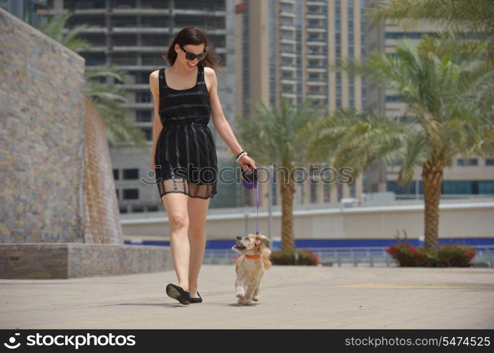 beautiful happy young woman in black dress with cute small dog puppy have fun on street