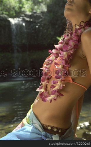 Beautiful Hawaiian Woman Sitting Next to Exotic Tropical Waterfall