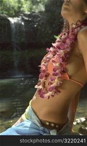 Beautiful Hawaiian Woman Sitting Next to Exotic Tropical Waterfall