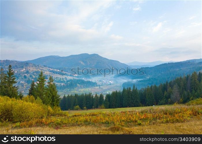 beautiful hazy autumn mountain and small village on mountainside (Carpathian. Ukraine)