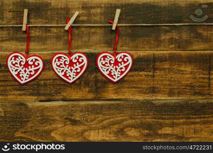 Beautiful hearts hanging on a wooden rustic background
