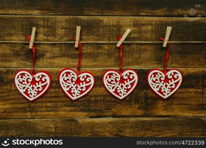 Beautiful hearts hanging on a wooden rustic background