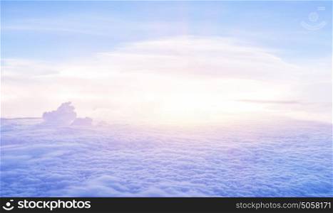 Beautiful heaven in the morning, flying over fluffy clouds, bright sun light, peaceful landscape, good weather, freedom concept
