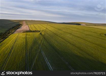 Beautiful high flying drone landscape image of rolling hills in English countryside with lovely warm light