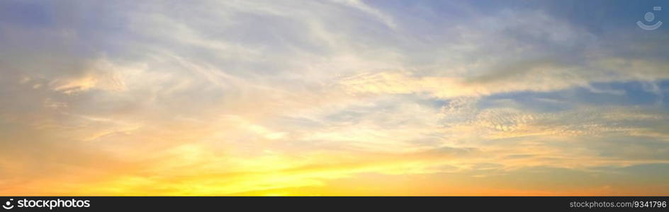 Beautiful high resolution panorama of orange and red sunset clouds in the evening sky.