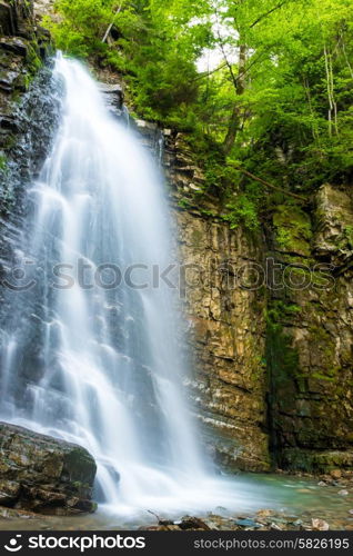 Beautiful high waterfall in the green forest