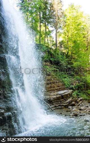 Beautiful high waterfall in the green forest