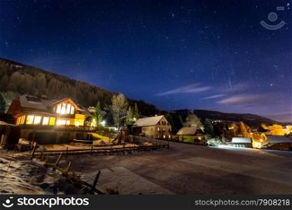 Beautiful highland Austrian chalet covered by snow at night