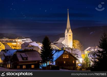 Beautiful highland Austrian town with big tower at night