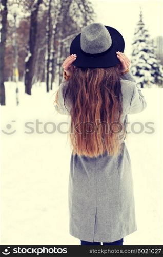beautiful hipster girl in winter hat. photo toned style instagram flters