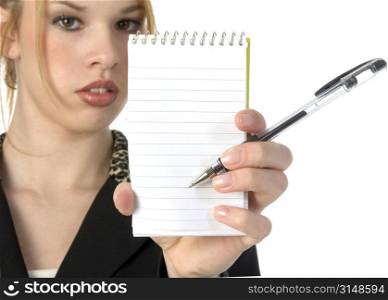 Beautiful Hispanic business woman holding blank lined note pad and pen towards camera. Add text.
