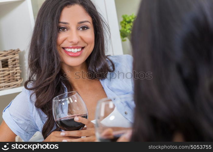 Beautiful Hispanic Latina woman with perfect teeth drinking wine at home with a female friend